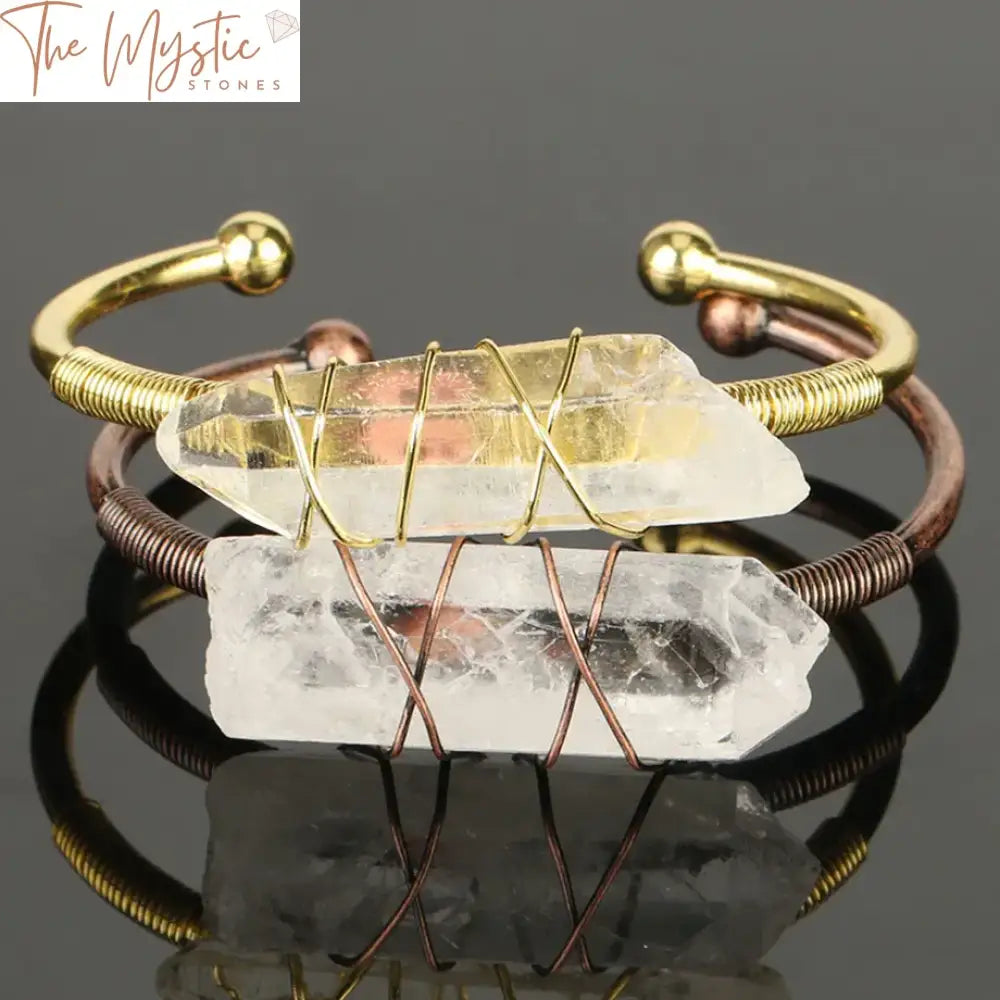 A collection of open cuff bracelets featuring irregularly shaped clear quartz stones in a wire wrap design.