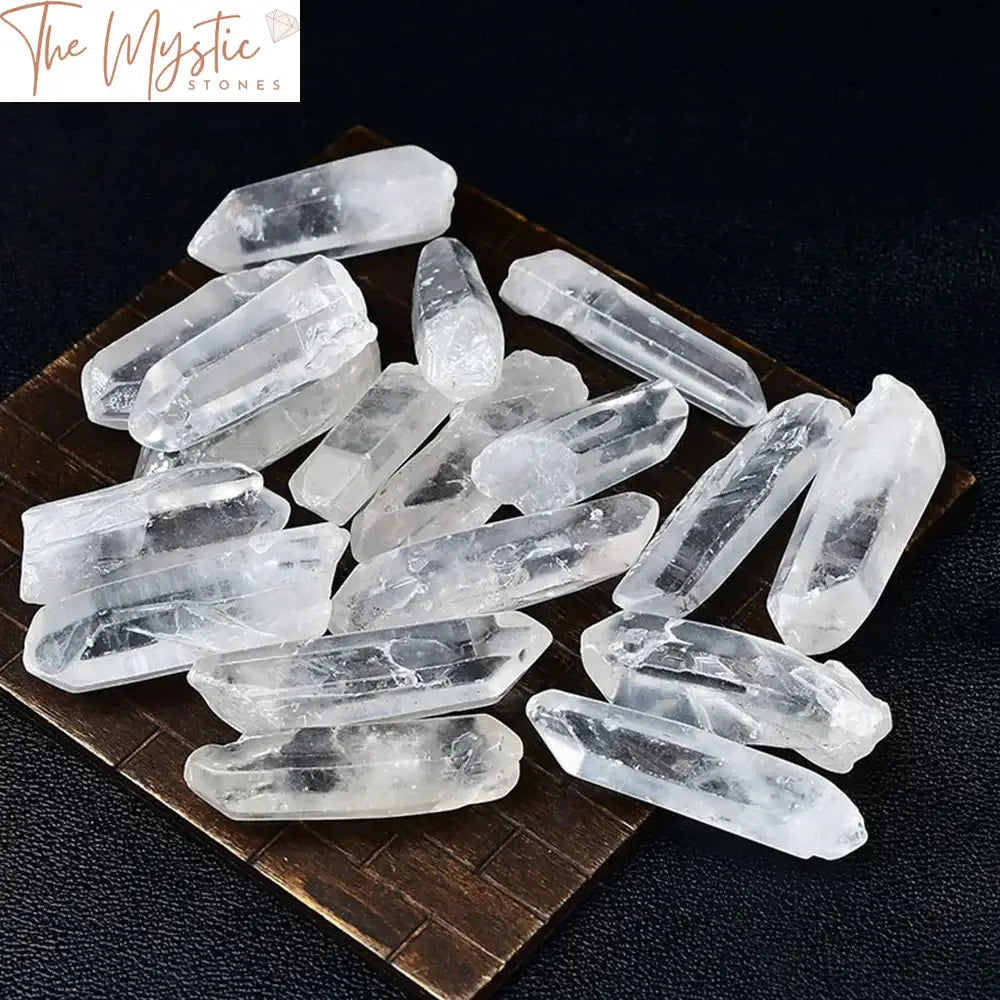 A collection of natural clear quartz crystal points in various sizes and shapes, with a transparent appearance.