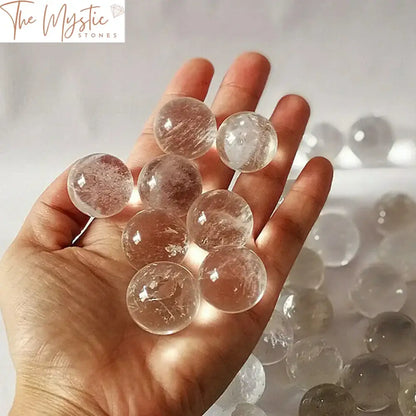 A set of five 18mm natural clear quartz crystal spheres, each smooth and translucent, arranged in a gentle cluster.