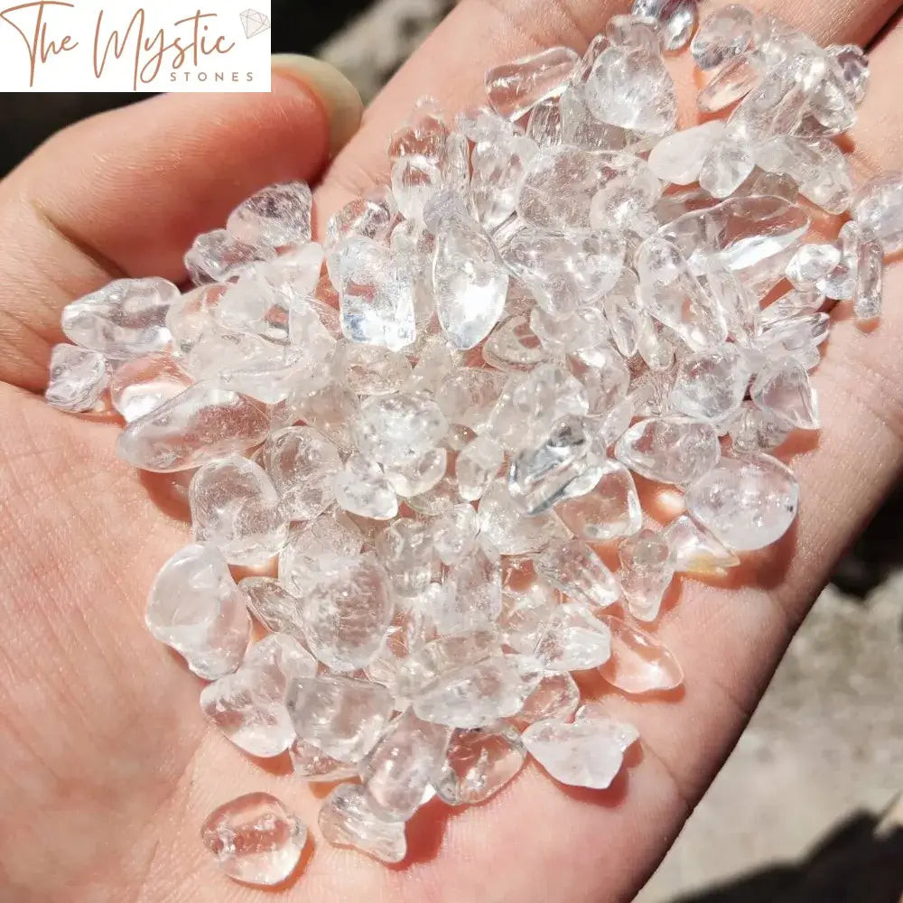 An assortment of small, polished clear quartz crystal chips scattered across a surface.