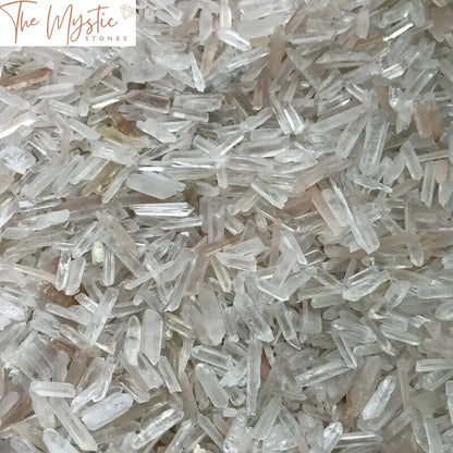 A collection of numerous natural clear quartz crystal points weighing 250 grams.