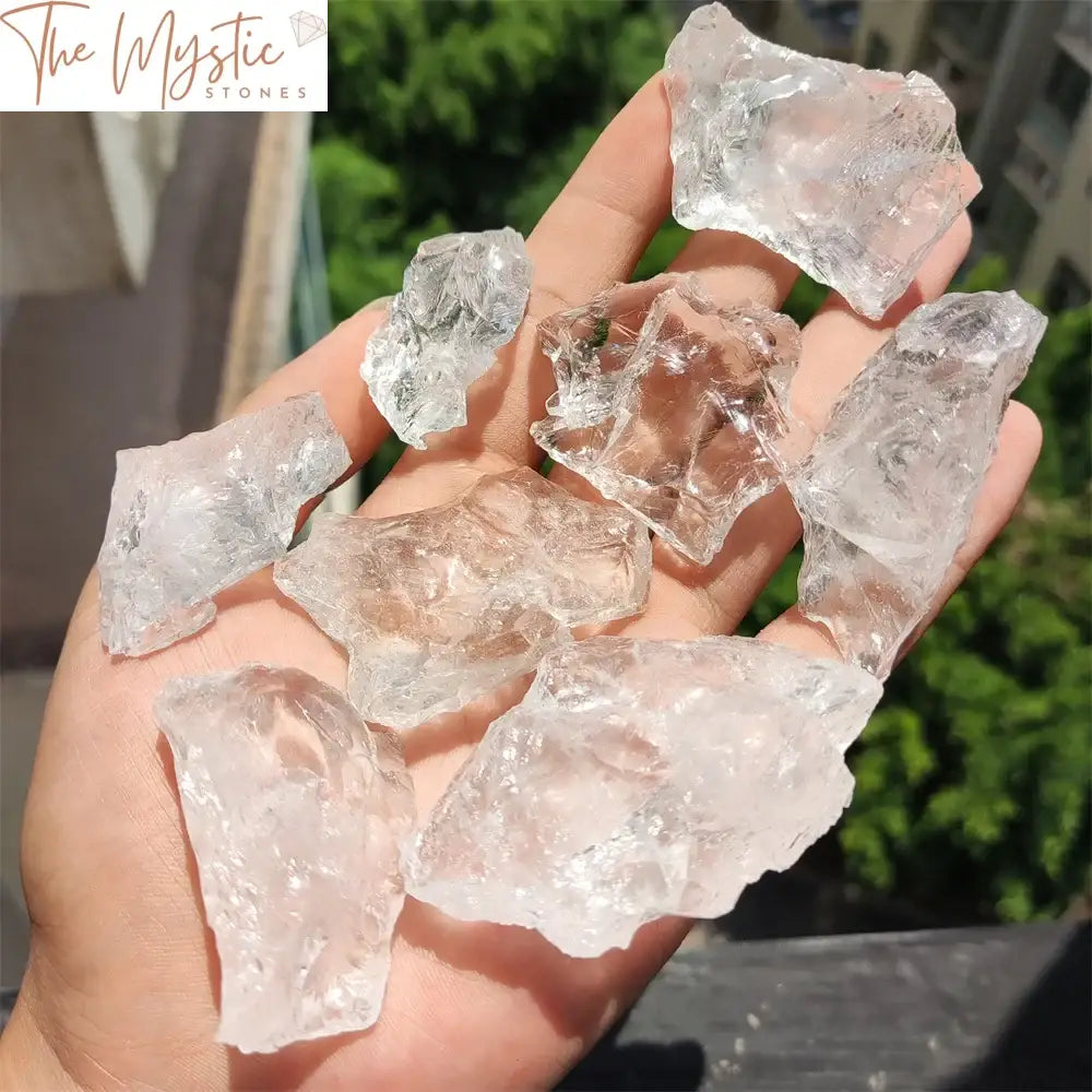 A smooth, transparent natural clear white crystal quartz stone with a raw and unpolished surface.