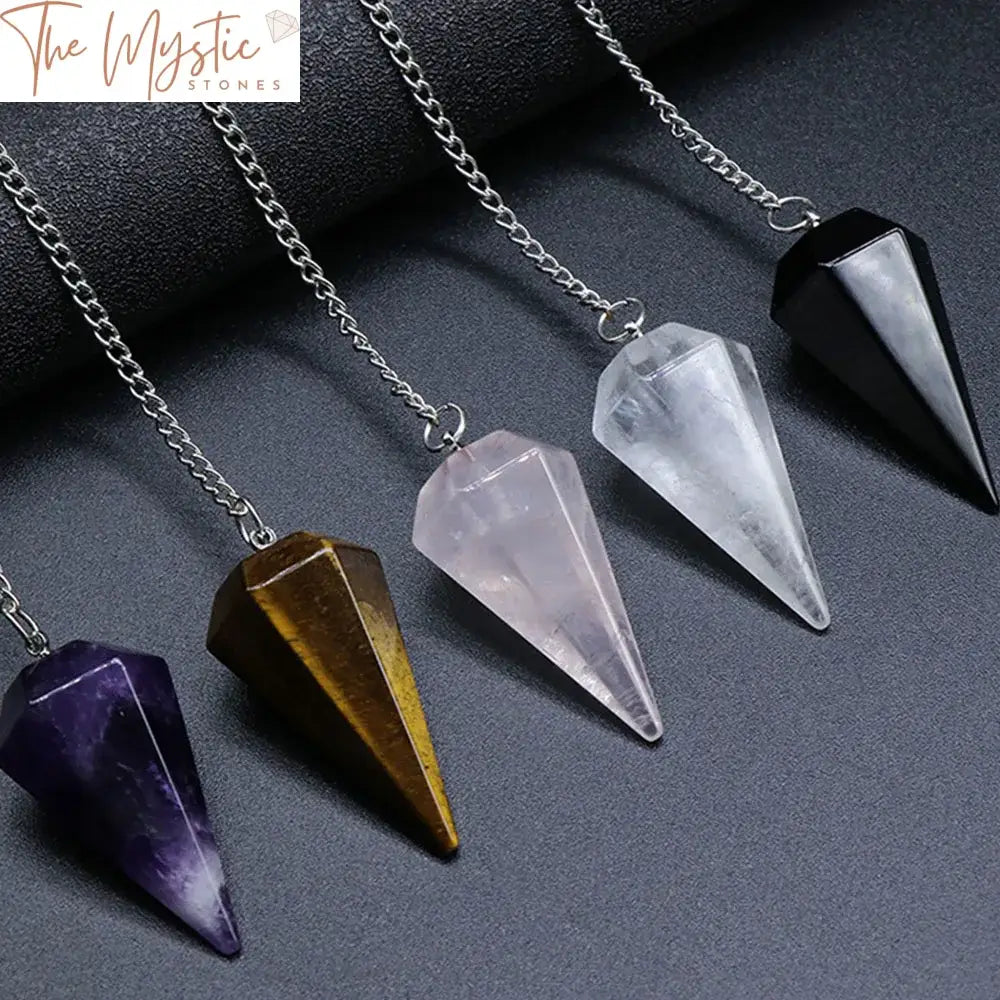 A natural clear quartz crystal pendulum with a hexagonal pointed design, suspended on a chain.