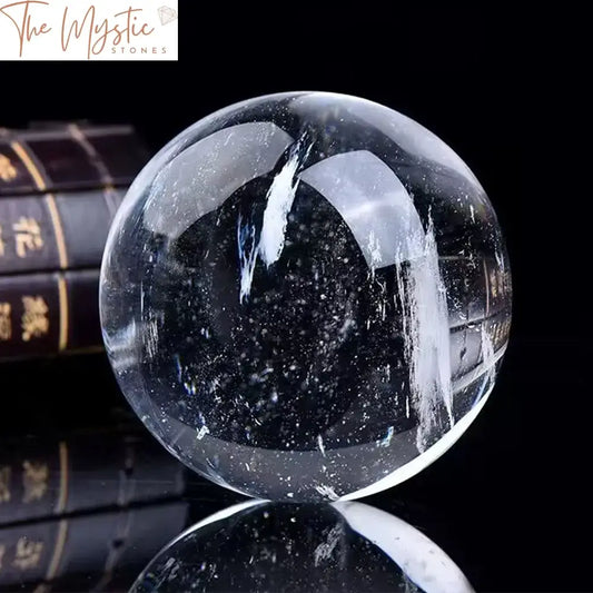 A 90-95mm white crystal clear smelting quartz ball is displayed on a smooth surface, glistening under soft lighting.