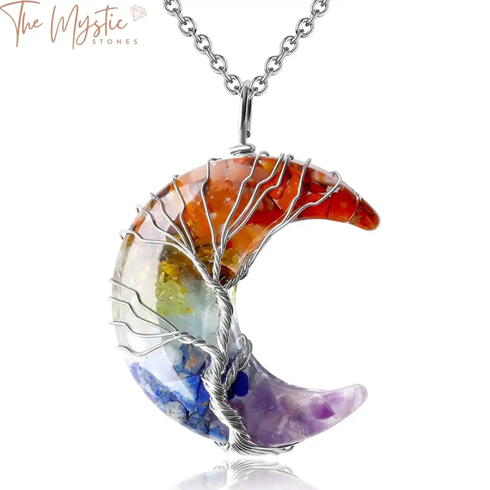 A beautifully crafted necklace featuring a Tree of Life design, intricately wire-wrapped within a crescent moon frame.