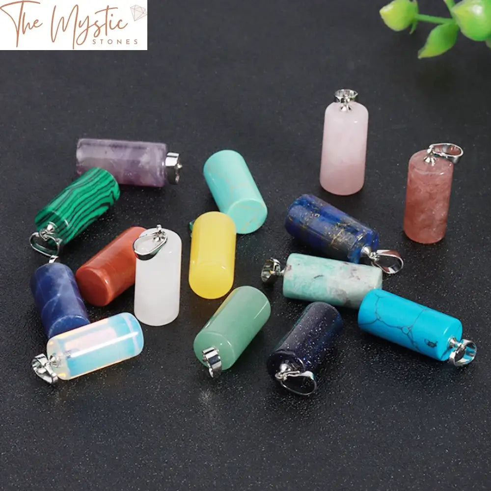 A collection of natural stone pendants shaped like sleek, cylindrical tubes, each with unique crystal patterns and colors.