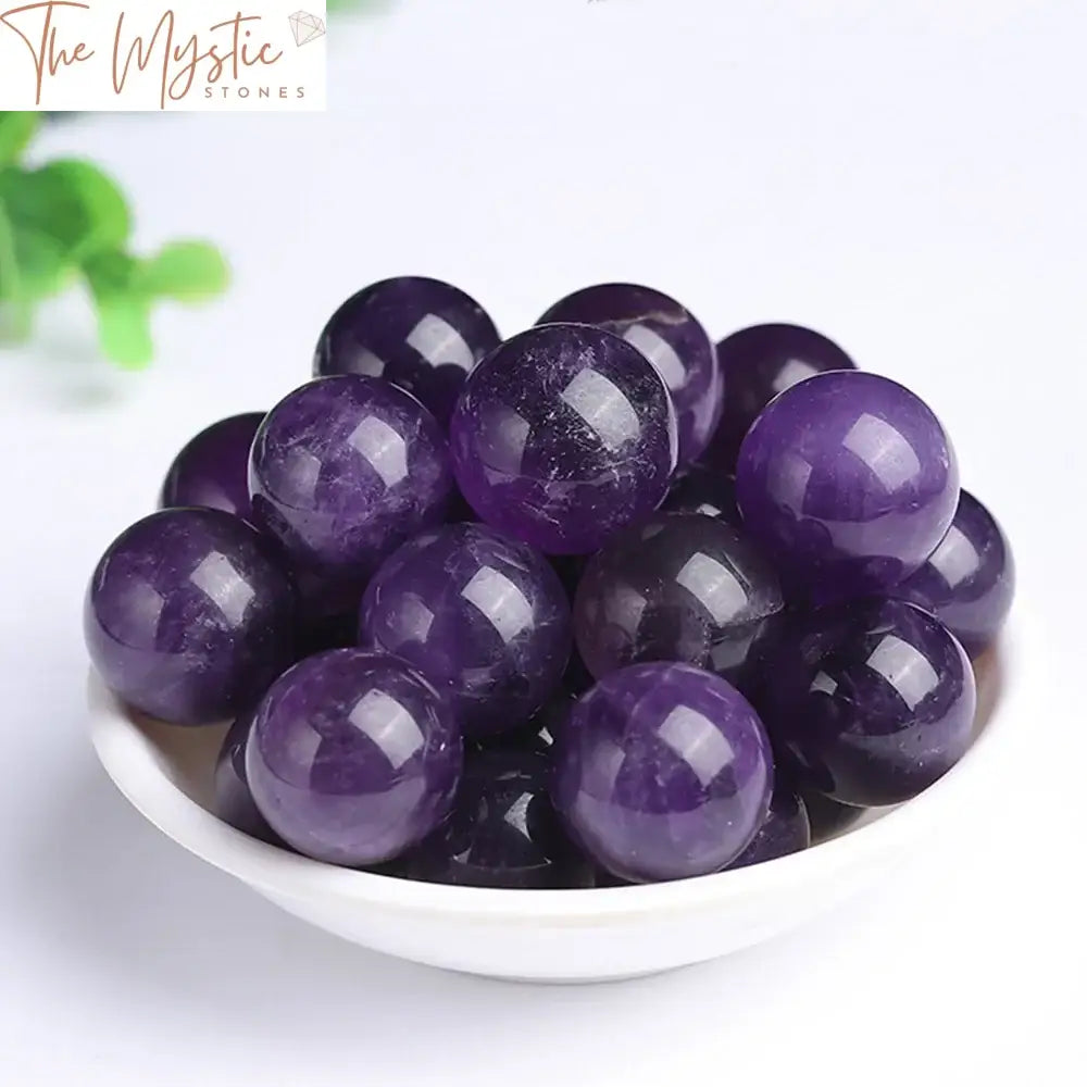 A 20mm Natural Dream Amethyst ball with swirling hues of purple and white, polished to a smooth and glossy finish.