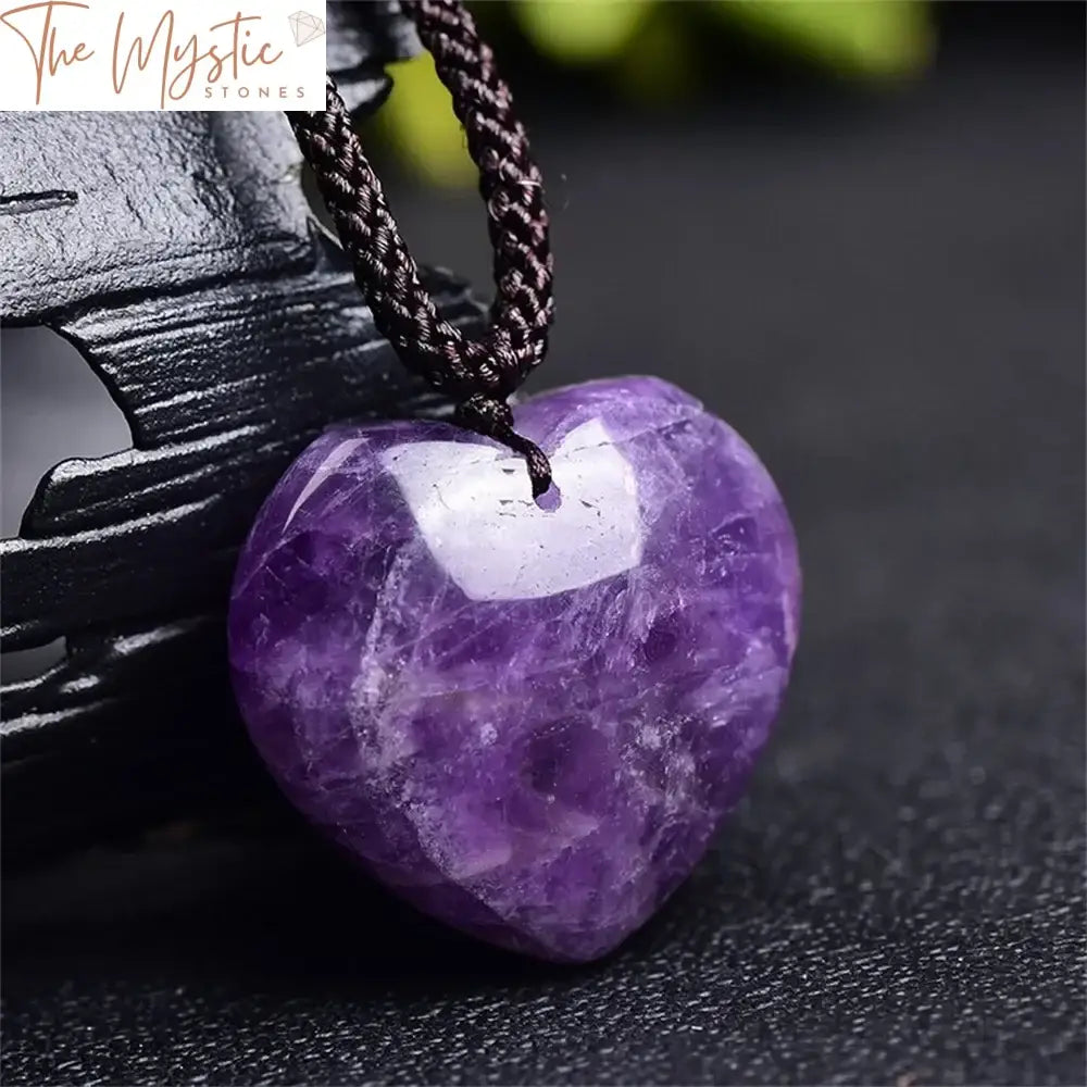 A heart-shaped pendant made from natural dream amethyst stone, featuring shades of purple with white and gray marbling.