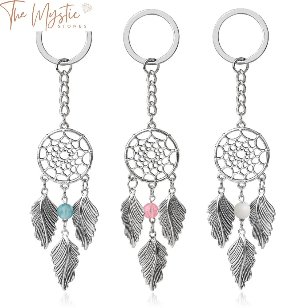 A silver-colored dreamcatcher keychain featuring intricate feather and leaf designs.