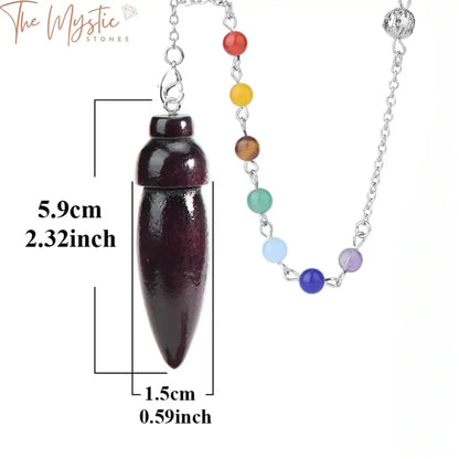 A handcrafted Egyptian pendulum made of natural wood, suspended from a chain adorned with seven chakra stones.