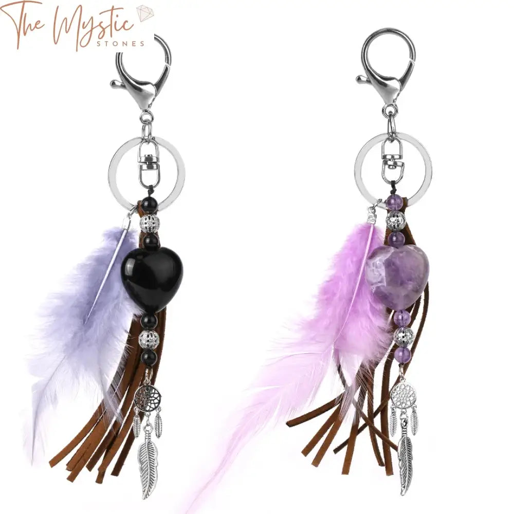 A collection of keychains featuring a variety of heart-shaped crystals and feather charms.