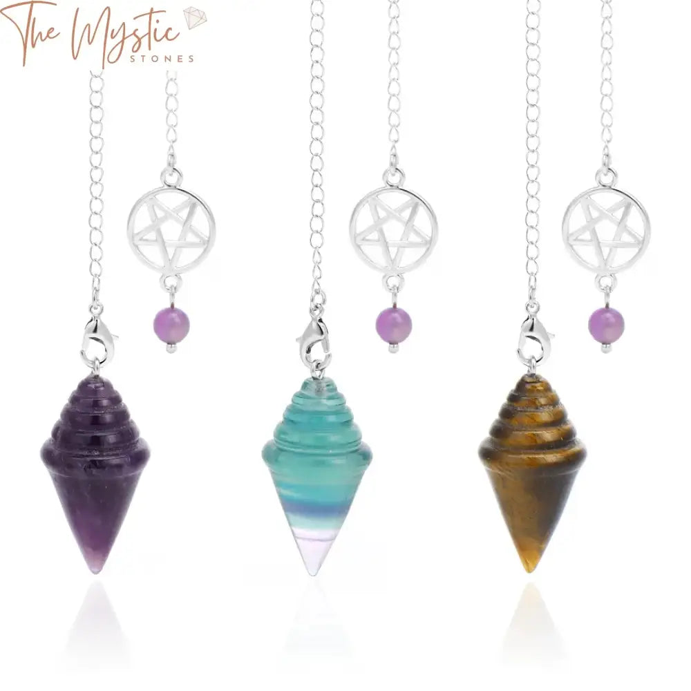 A triangular crystal pendulum, featuring a blend of colorful fluorite and amethyst stones, hangs elegantly.