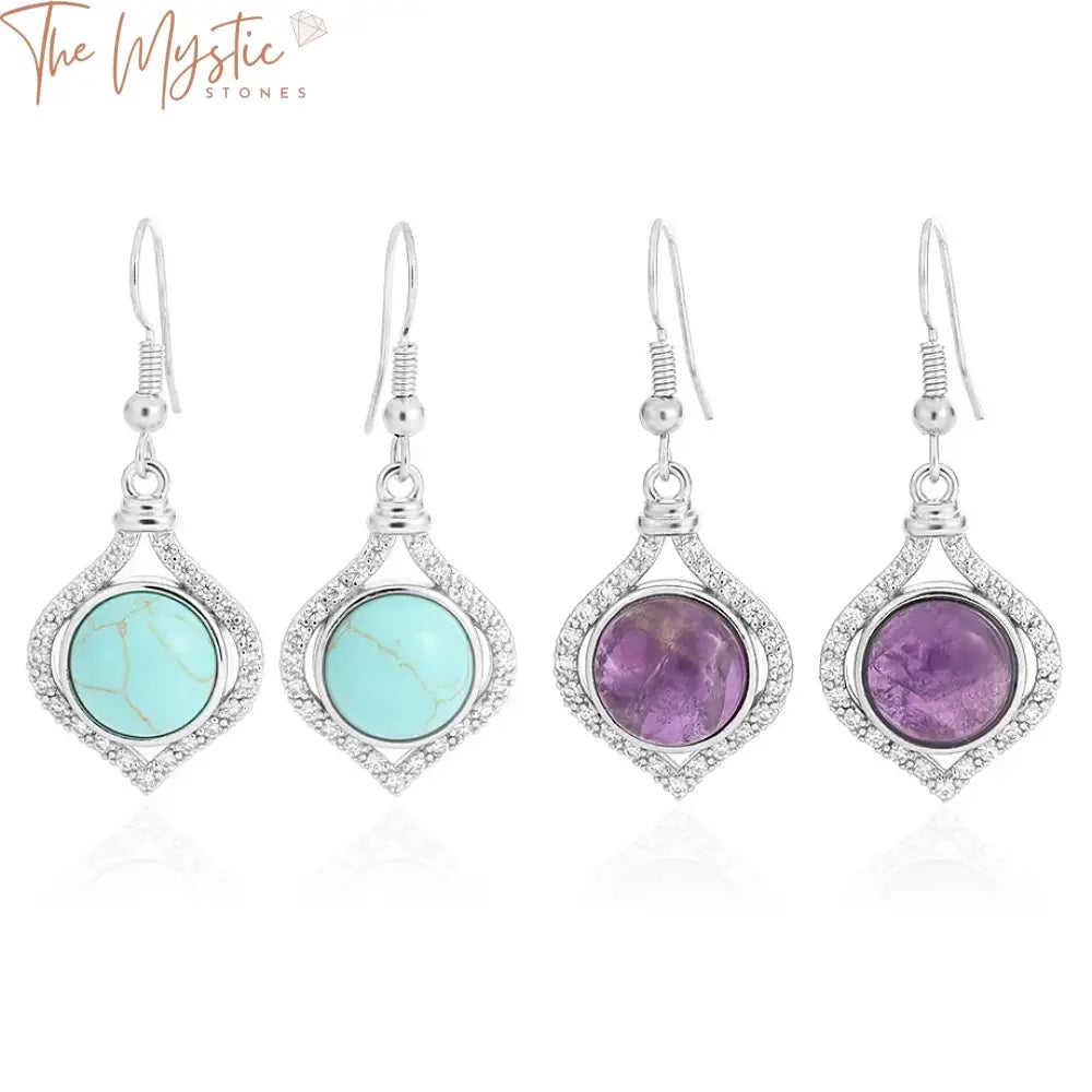 A pair of elegant drop earrings featuring a round cabochon design.