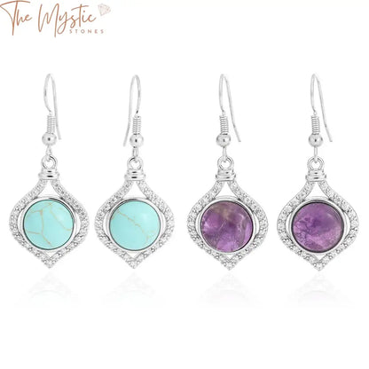 A pair of elegant drop earrings featuring a round cabochon design.