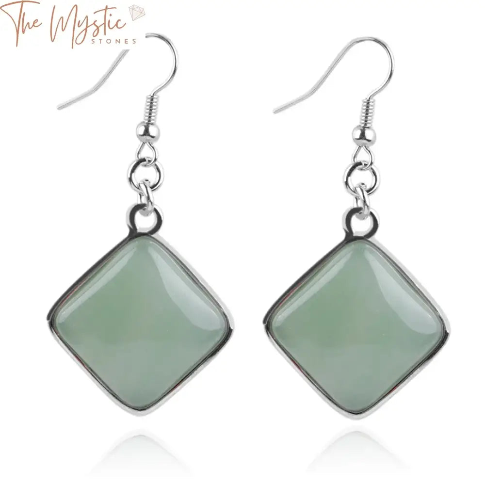 A pair of dangle earrings featuring square-shaped pendants made of natural stones.