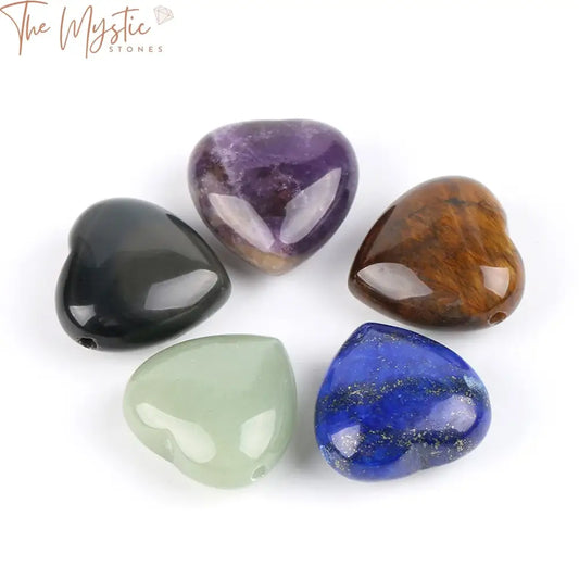 A selection of heart-shaped gemstone pendants arranged in a neat row.