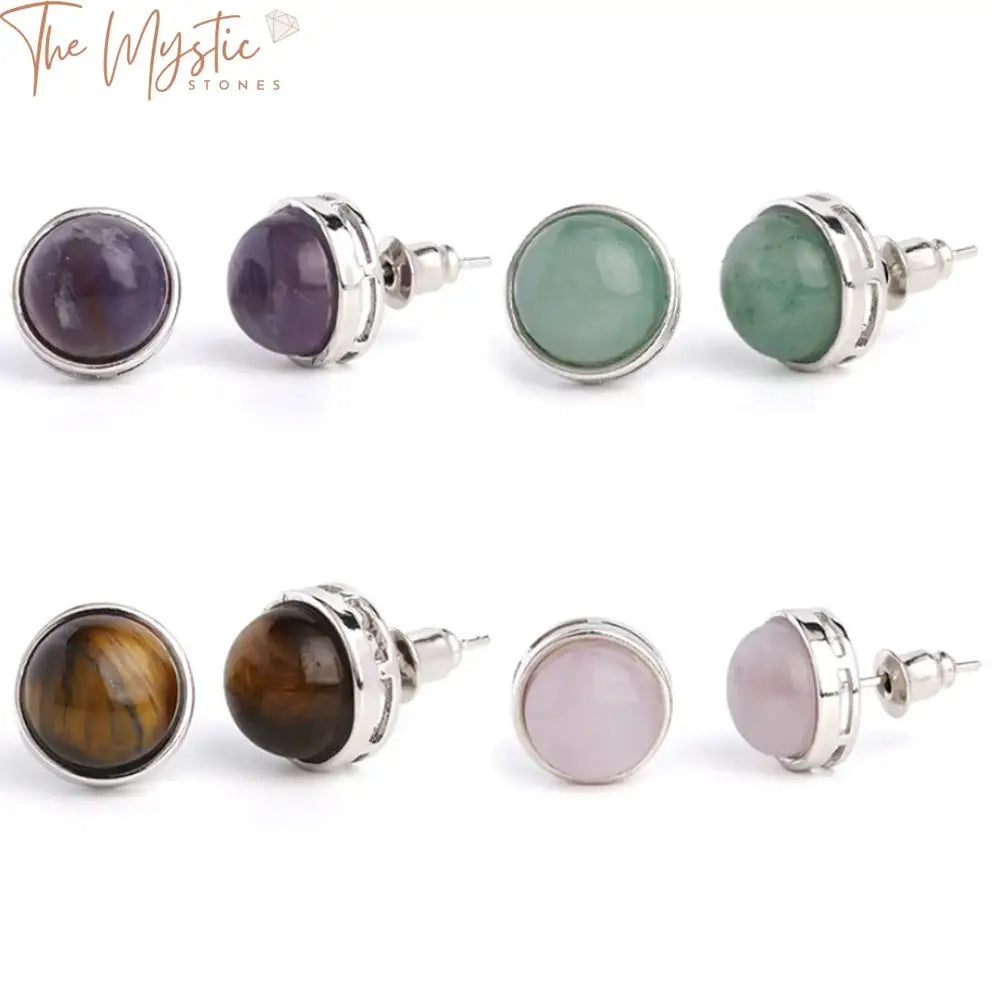 A pair of round stud earrings is displayed, featuring natural gemstone crystals.