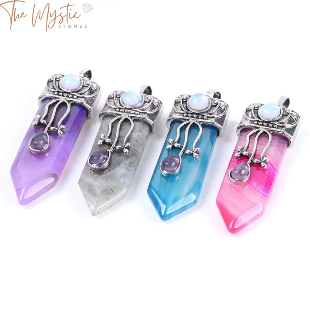 A collection of five Reiki natural gemstone pendants shaped like swords, displayed on a plain background.