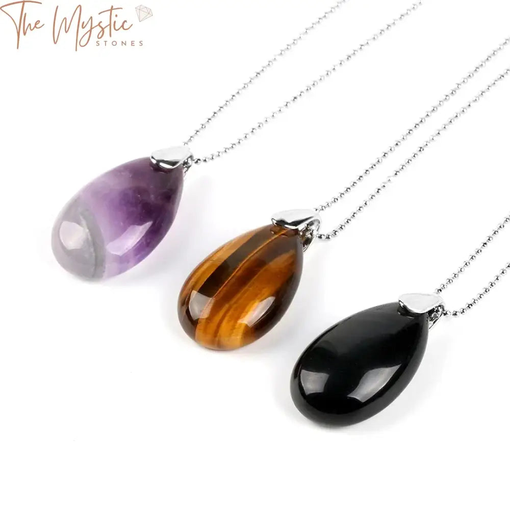 A collection of water drop-shaped gemstone pendants hanging from delicate chains.