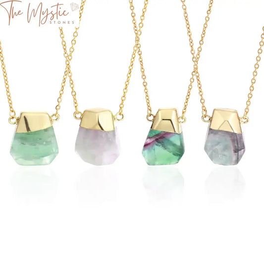 A stunning necklace featuring an irregularly faceted fluorite crystal pendant in vibrant shades of green and purple.