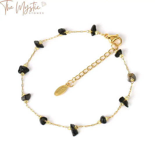 A collection of gold-colored stainless steel chain bracelets featuring natural stone chip beads of pink quartz.