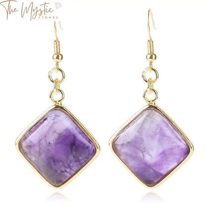 A pair of geometric dangle earrings feature a gold-tone design with rhombus shapes and square beads.