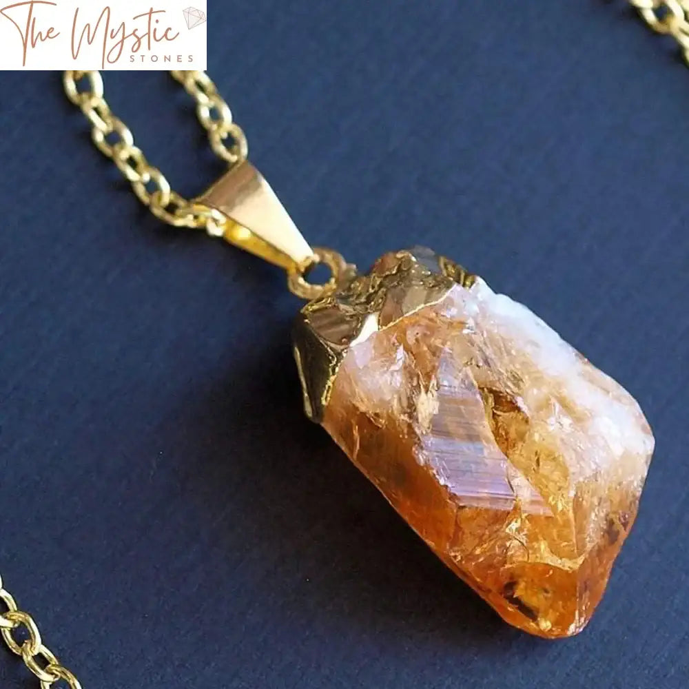 A close-up image of a natural raw citrine pendant featuring an irregularly shaped, translucent golden-yellow crystal.