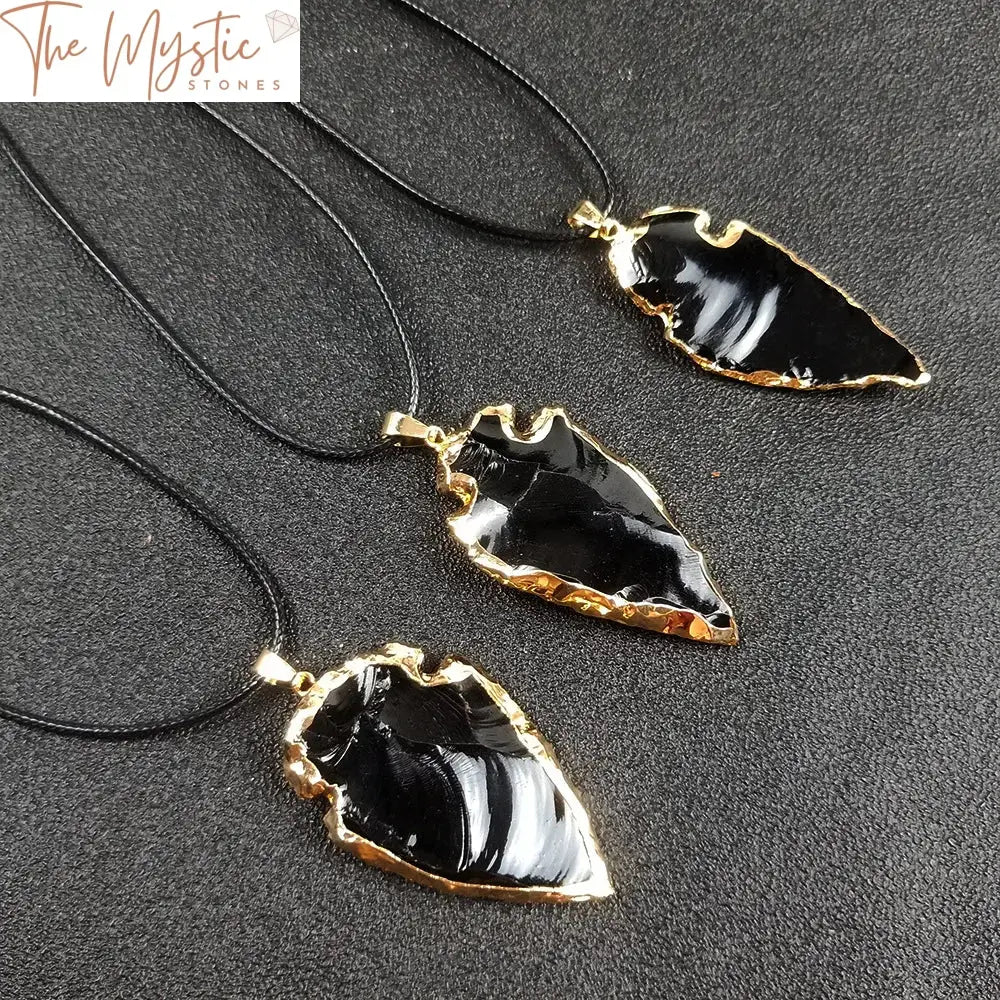 A necklace featuring an irregular arrowhead pendant made from natural black obsidian crystal.