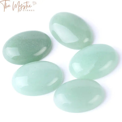 A single polished green aventurine cabochon bead in an oval shape, displayed against a neutral background.