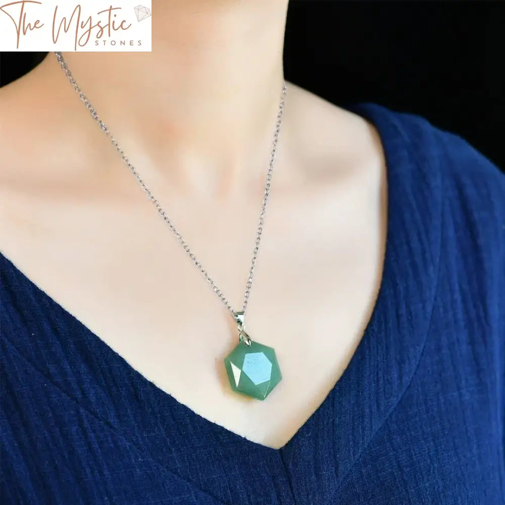 A close-up image of a hexagonal crystal pendant necklace featuring a green aventurine stone.