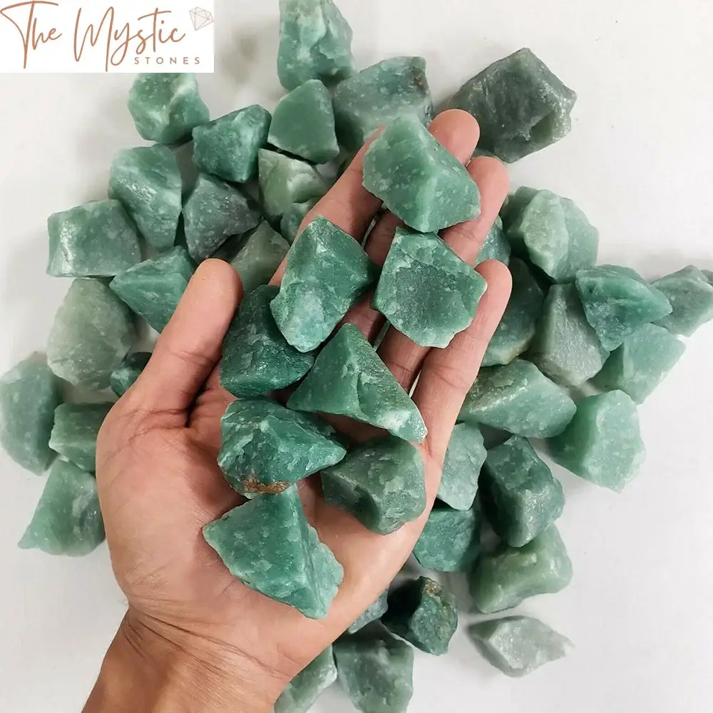 A collection of raw, rough green aventurine crystals, showcasing various shades of green.