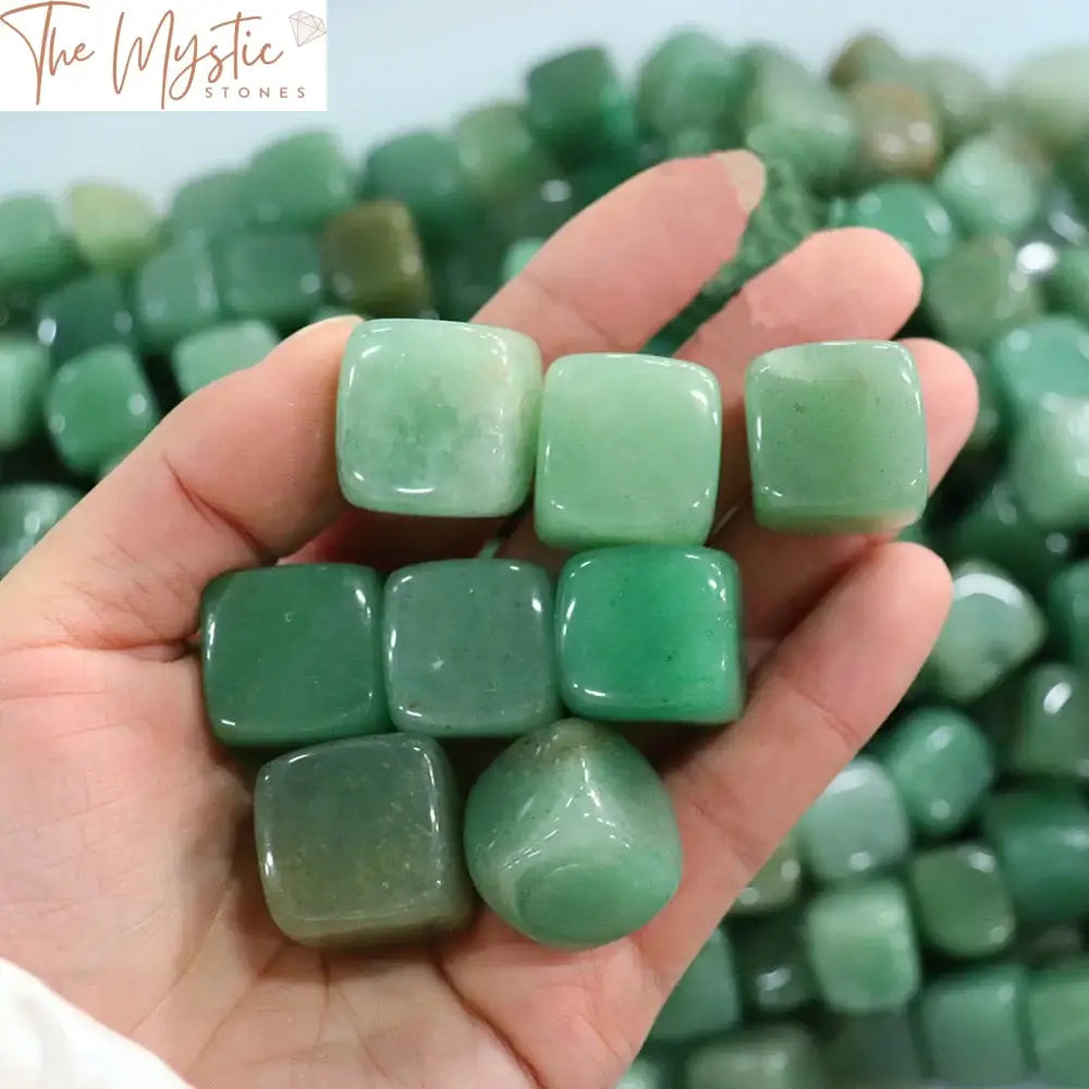 A collection of smooth, polished green jade stones with a tumbled, shiny surface.