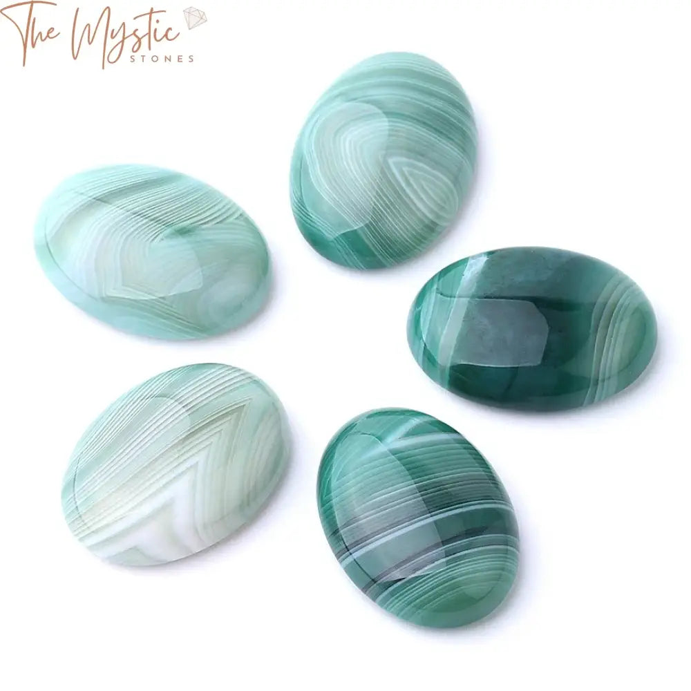 A collection of oval-shaped cabochons made from natural stone agates, featuring varying shades of green veins.