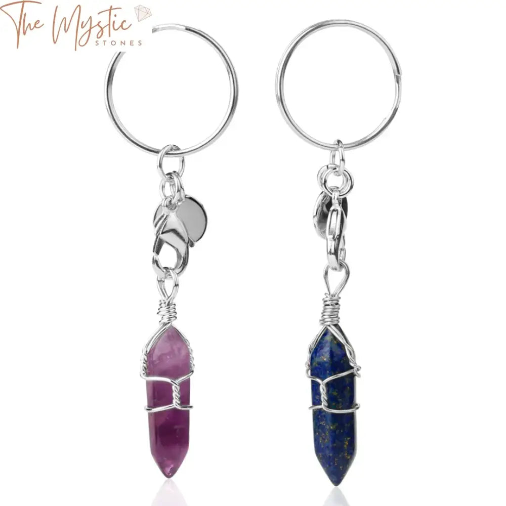 A collection of natural stone keychains featuring bullet-shaped, pointed healing crystal pillars.