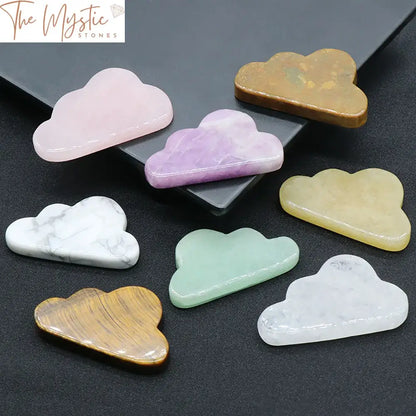 A collection of delicately hand-carved rose quartz crystal figurines shaped like clouds, displayed on a smooth surface.