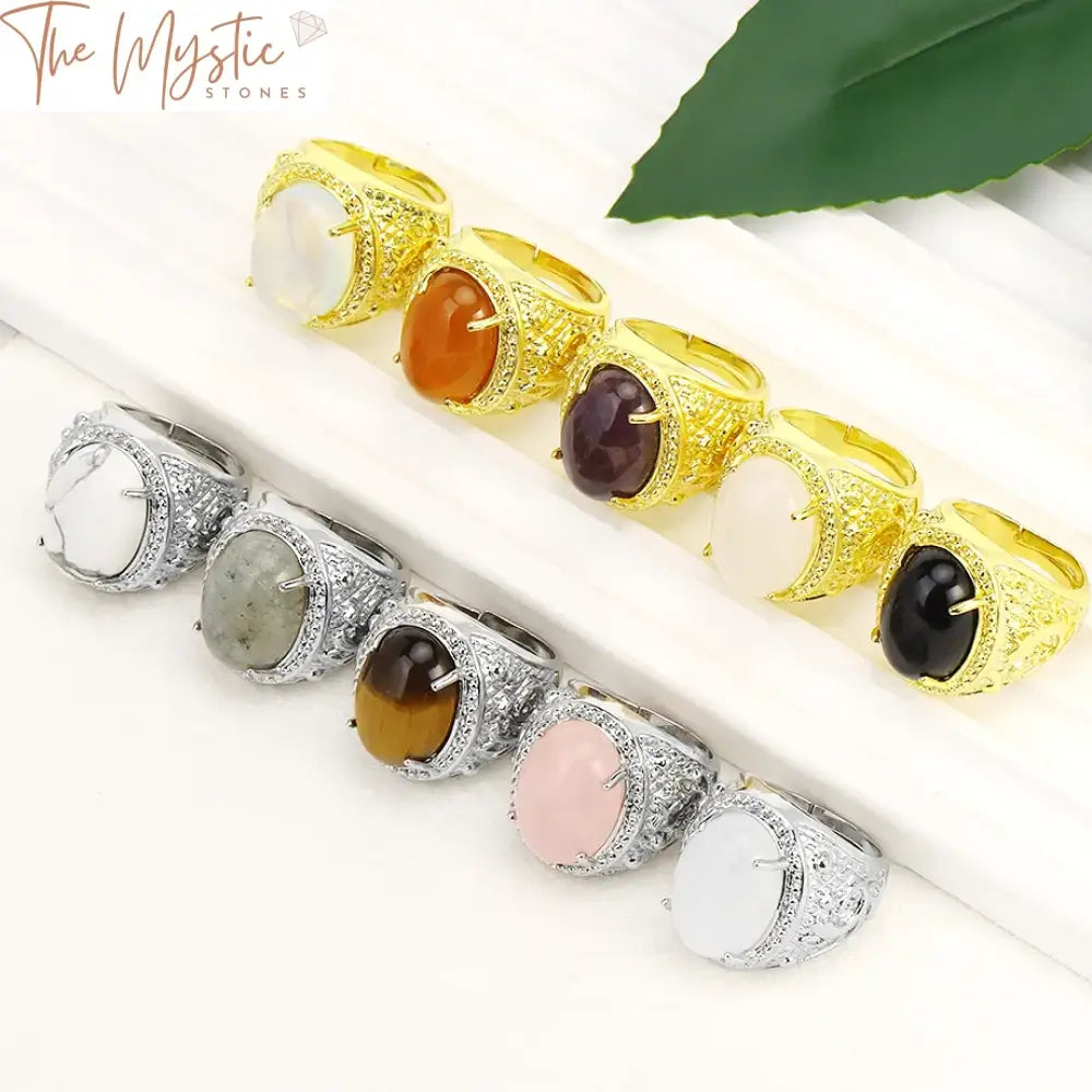 A collection of crystal rings featuring oval egg-shaped stones set in metal bands.