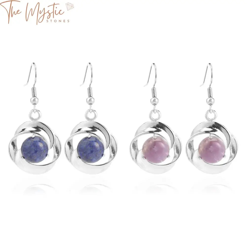 A pair of elegant earrings featuring round cabochon beads made from natural stone.