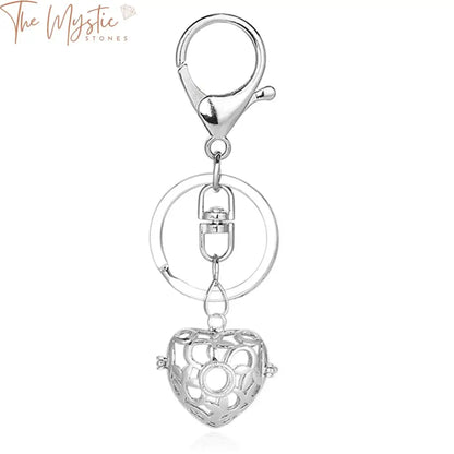 A high-quality metal car keychain featuring a 3D design with a love heart cage pendant.