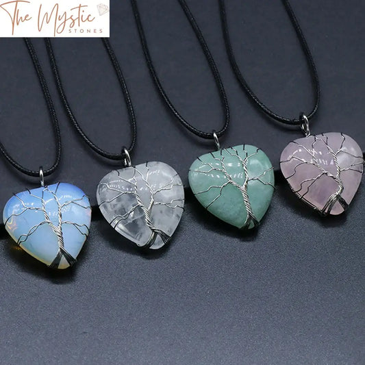 A heart-shaped pendant featuring a wire-wrapped tree of life design, crafted from a natural healing crystal.