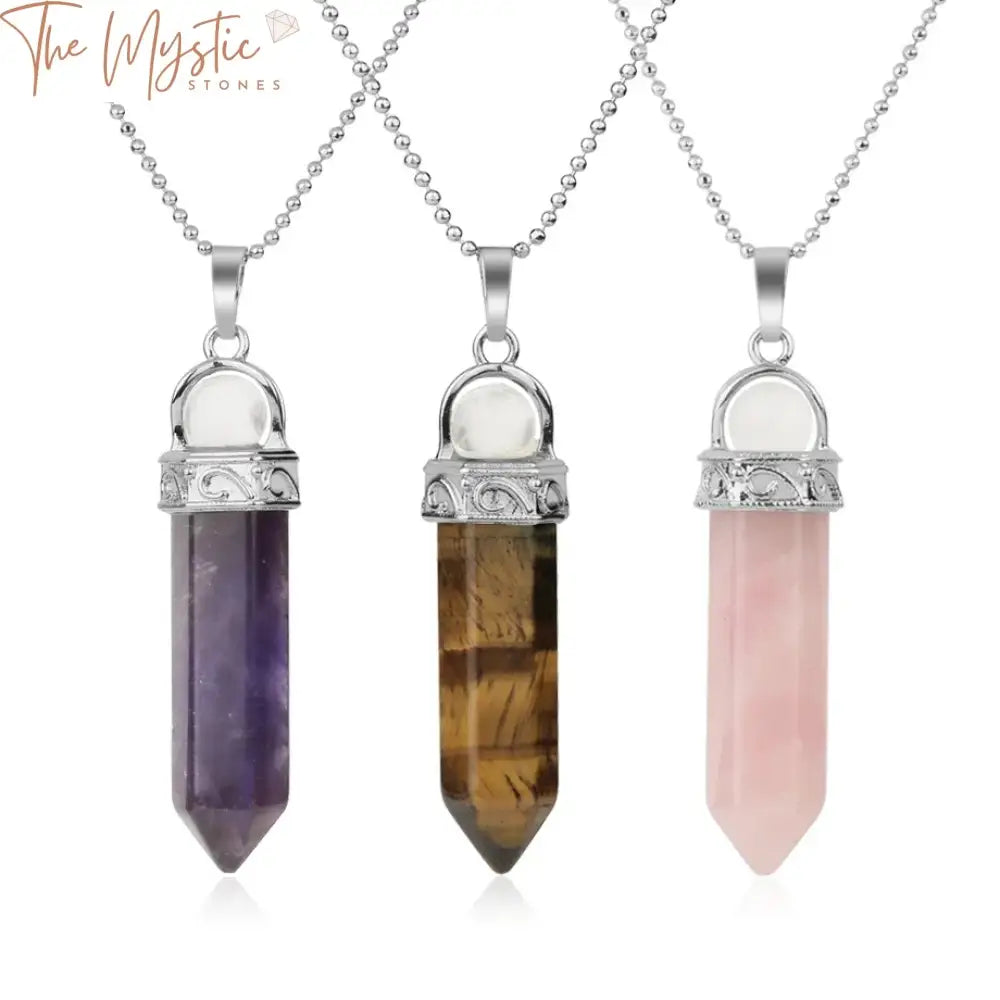 A white, pink, and purple crystal pendant shaped like a pointed hexagon column hangs from a necklace chain.