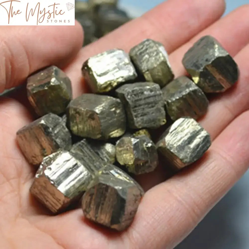 A collection of natural cubic pyrite stones, also known as fool's gold, with rough, irregular surfaces.