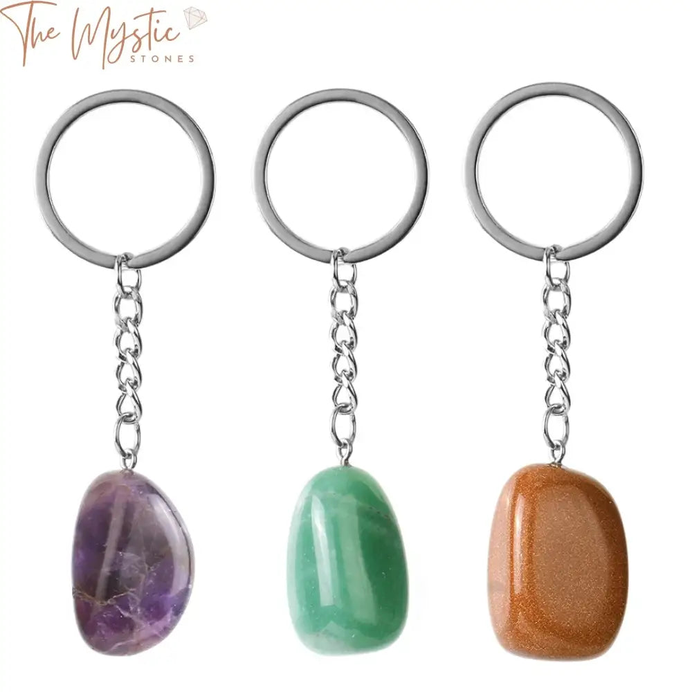 A collection of natural stone keychains featuring irregular crystals with a polished finish.