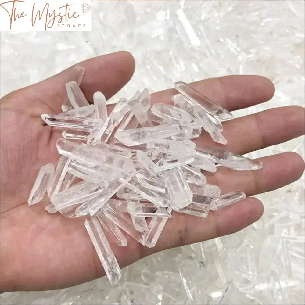 A collection of irregularly shaped clear quartz crystal points arranged on a surface.