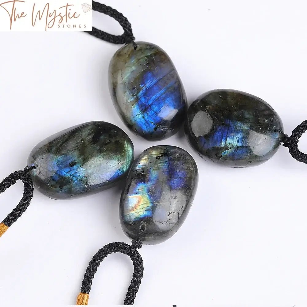 A polished, irregular-shaped labradorite pendant with iridescent blue and green hues, set against a neutral background.