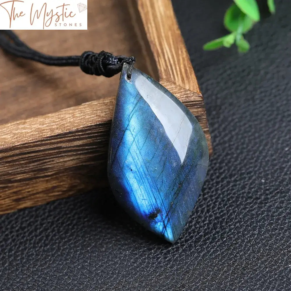 A leaf-shaped pendant made of natural labradorite exhibits a striking blue flash, resembling moonstone.