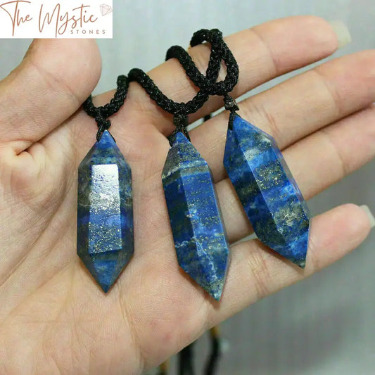 A Lapis Lazuli crystal double-point pendant featuring a deep blue hue with flecks of gold pyrite.