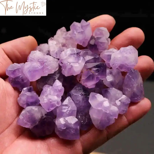 A collection of natural rough lavender amethyst clusters and gravel, showcasing varying sizes and raw formations.