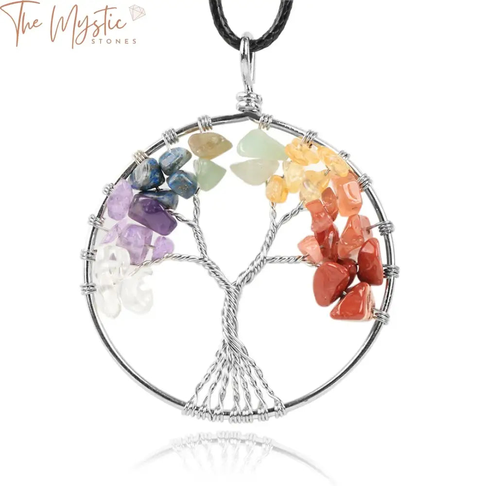 A necklace pendant featuring a tree of life design made with natural crystals representing the 7 chakras.