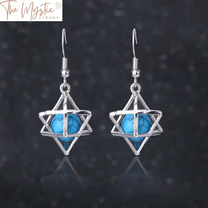 A pair of earrings featuring a hexagram design made from natural stone.