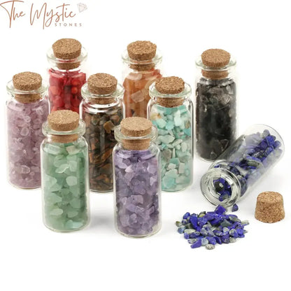 A collection of mini glass bottles filled with small, natural chip tumble stones in assorted colors.